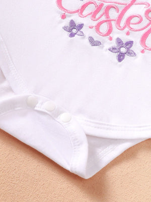 White cotton baby bodysuit with pink and purple floral embroidery and snap closures.