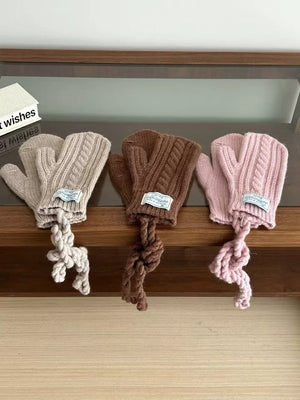 Cozy cable knit acrylic gloves in beige, brown, and pink with braided ties.