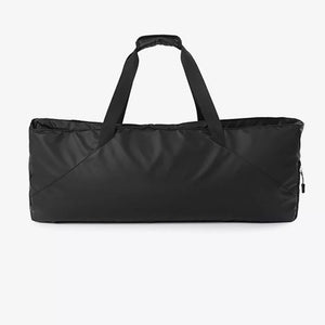Black color block travel bag with dual handles and a zippered side pocket.