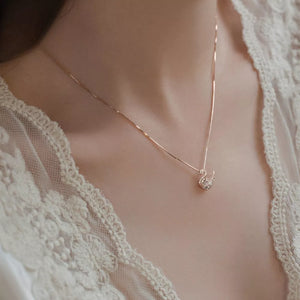 Rose gold swan pendant necklace with zircon details on a delicate chain.