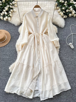 Off-white textured tiered long sleeve button-down dress with tie waist