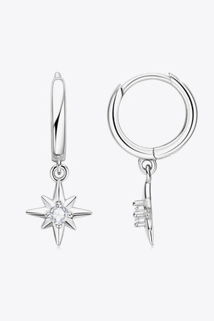 Silver hoop earrings with dangling star charms featuring a central crystal