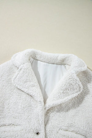 White teddy bear collarless jacket with a clasp closure and lapel collar.