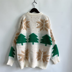Cream knit sweater with green Christmas trees and tan snowflake appliqué.