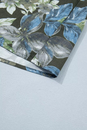 Botanical print cotton shirt with ruffle sleeves and a dark floral pattern.