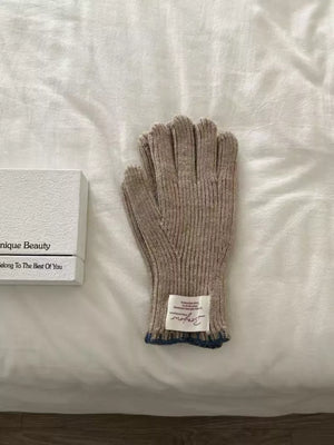 Brown ribbed knit gloves with blue trim and a scalloped cuff detail.
