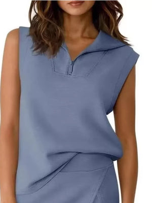 Blue sleeveless quarter-zip top and asymmetrical skort ensemble