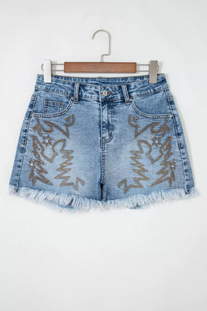 Embroidered denim shorts with distressed frayed hem and western boot design.