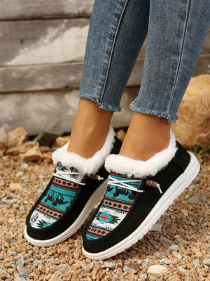 Southwestern print faux fur lined loafers in black with white laces and white soles.