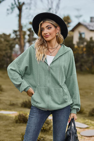 Sage textured cable knit zip-up hoodie with drawstring hood and pockets.