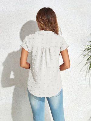 Textured dot poplin shirt in light blue with short sleeves and a collared neckline.