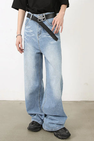 Oversized denim jeans in medium wash with distressed details and a wide leg.