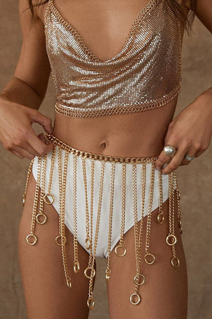 Gold chainmail belt with cascading chains and rings, worn over white bottoms.