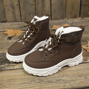 Chocolate lace-up boots with plush accents and white soles.