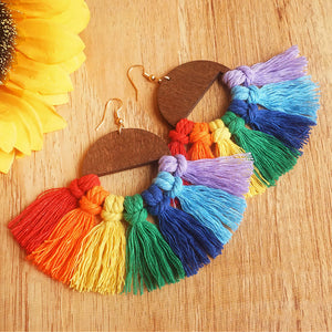 Rainbow fan tassel earrings with wooden half-circle detail.