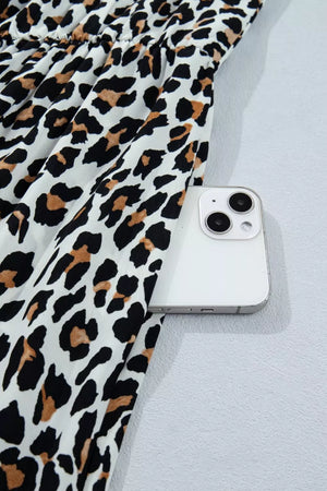 Leopard print midi dress with cinched waist detail and side pocket for a phone.