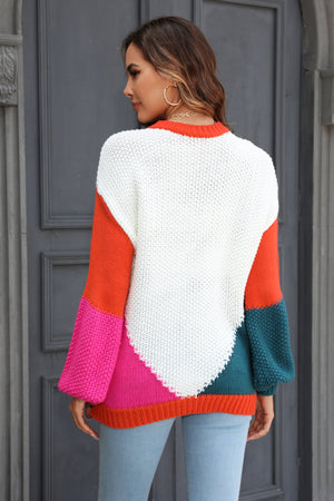 Colorblock knit sweater with sculpted sleeves in white, orange, pink, and teal acrylic.