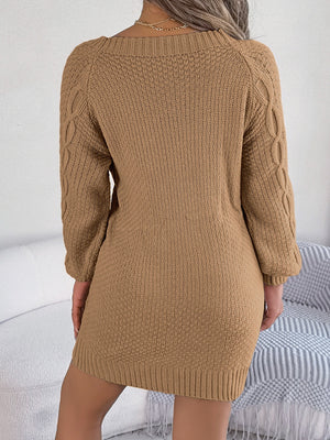 Camel cable knit mini dress with belted detail and textured sleeves.