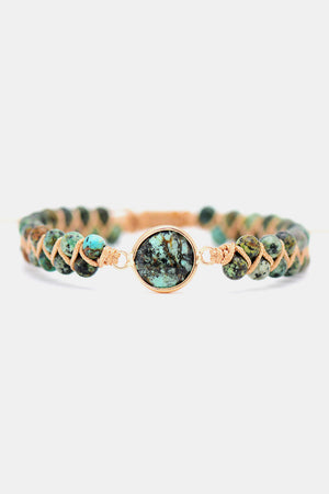 Turquoise beaded bracelet with braided cord and a central stone accent