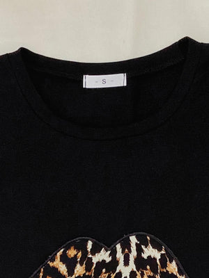 Black leopard lip tee with crew neck and short sleeves.