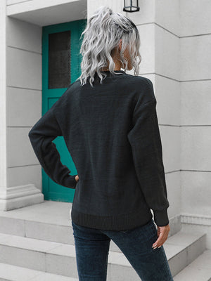 Black acrylic knit sweater with button detail and crew neck, casual style.