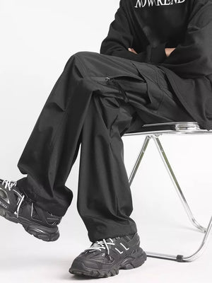 Men's black relaxed fit cargo sweatpants with zippered pockets and ankle drawstrings.