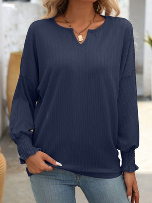 Dark Navy textured blouson top with split neckline and smocked cuffs.