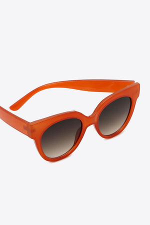 Sunset cat-eye sunglasses in deep red with gradient lenses.