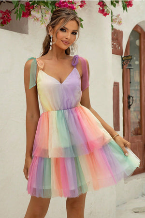 Rainbow tulle mini dress with tie straps and tiered skirt.