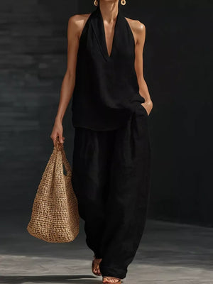 Black halter neck top with flowing wide-leg pants set, a breezy casual outfit.
