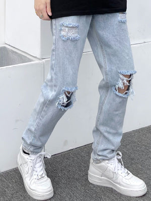 Light blue distressed slim fit 100% cotton jeans with ripped knees and frayed hems.