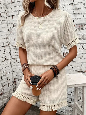 Textured knit set in cream with fringe detail on short sleeves and hem.