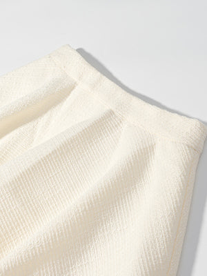 Textured cream two-piece set with buttoned top, showing fabric detail