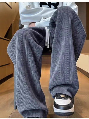 Men's gray textured wide leg sweatpants with a drawstring waist.