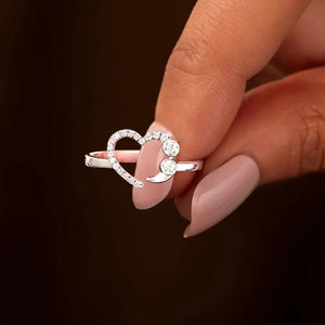 Sterling silver ring with heart and semicolon design, accented with clear stones.
