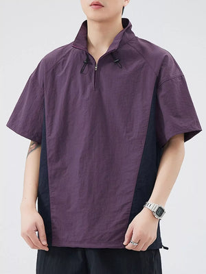 Lightweight violet pullover activewear top with quarter zip and contrasting dark side panels.
