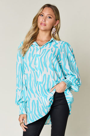 Tiffany blue zebra print blouse with shirred cuffs and balloon sleeves.