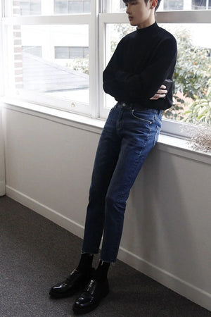 Slim-fit jeans in medium wash denim with raw hems.