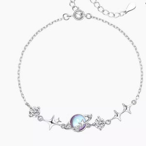 Silver celestial bracelet with planet charm, stars, and cubic zirconia accents.