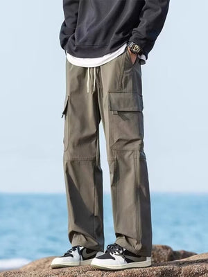 Relaxed fit army green cargo pants with flap pockets and drawstring waist.