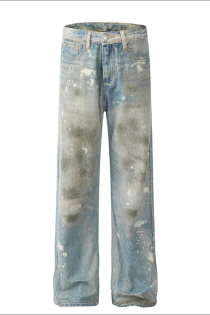 Distressed wash wide leg denim jeans in medium blue with paint splatters and faded details.