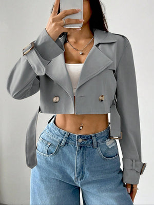 Gray cropped double-breasted trench coat with belt and adjustable cuffs.