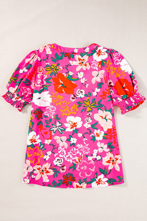 Hot pink floral print tunic with gathered puff sleeves and smocked cuffs.