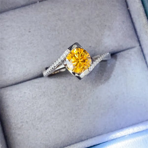 Radiant yellow diamond swirl ring in silver with diamond accents.