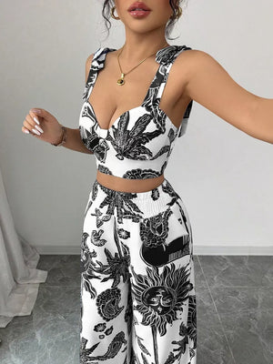 Black and white tropical print crop top with tie straps and wide-leg pants set.