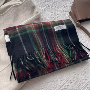 Classic wool plaid scarf with tassels in burgundy, green, and yellow on black.