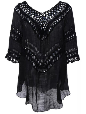 Black flowy cover-up with crochet trim and cutout details.