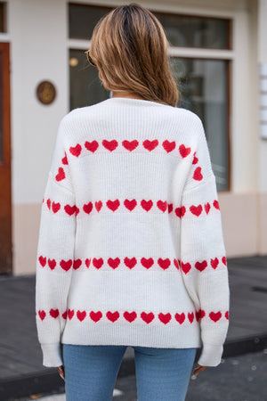 White knit pullover sweater with red heart stripes.