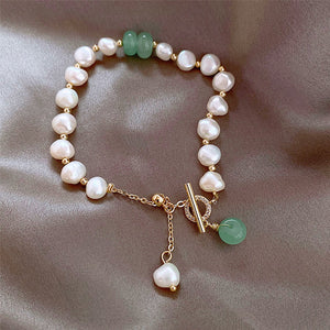 Pearl and green stone toggle bracelet with gold accents and pearl drop