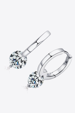 Silver huggie hoop earrings with a single sparkling solitaire gemstone.